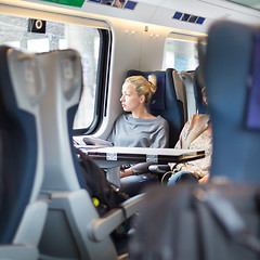 Image showing Lady traveling by train.