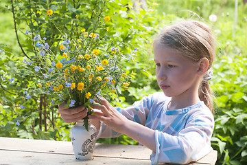 Image showing little girl making bunch of flowers