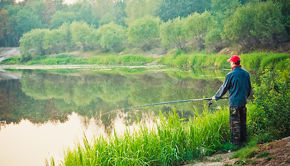 Image showing Fisherman Casting On Calm River