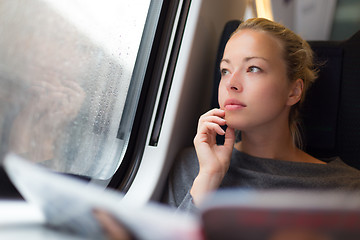 Image showing Lady traveling by train.