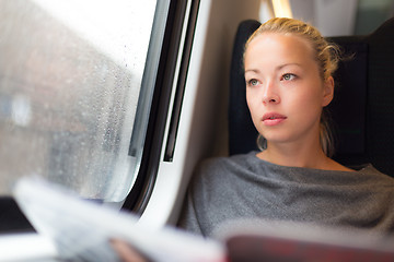 Image showing Lady traveling by train.