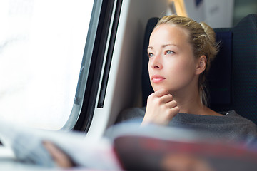 Image showing Lady traveling by train.