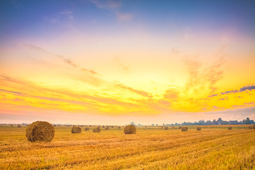 Image showing Sunrise field, hay bale in Belarus.