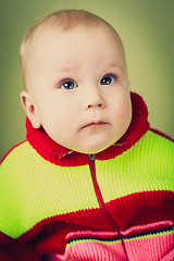 Image showing Portrait Of Sad Baby Boy On Green Background