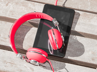 Image showing Red colored headphones and tablet PC