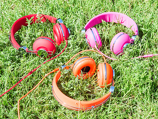 Image showing Set of three varicolored colorful headphones 