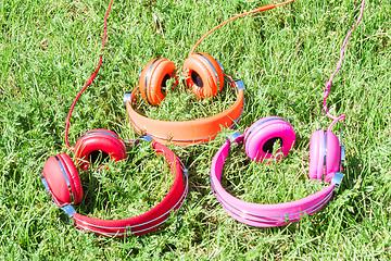 Image showing Three varicolored vibrant colorful headphones