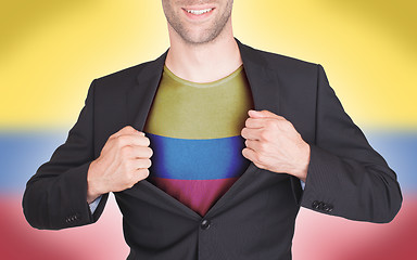 Image showing Businessman opening suit to reveal shirt with flag