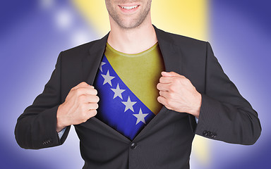 Image showing Businessman opening suit to reveal shirt with flag