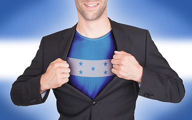 Image showing Businessman opening suit to reveal shirt with flag