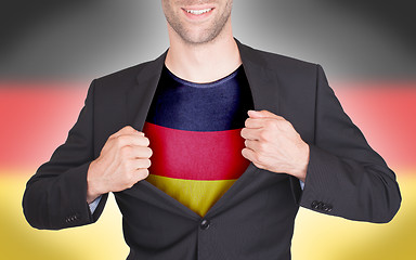 Image showing Businessman opening suit to reveal shirt with flag