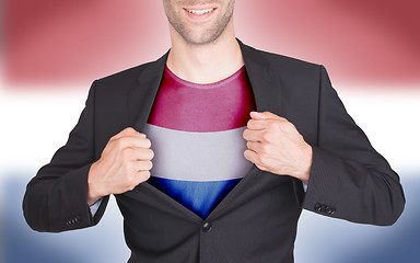 Image showing Businessman opening suit to reveal shirt with flag