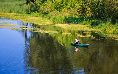 Image showing Man Fishing Out Of A Row Boat