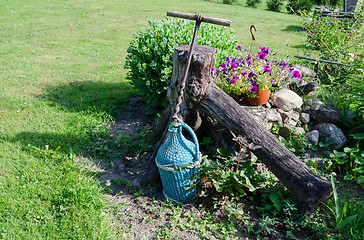 Image showing wine bottle wrapped blue twig and stylized opener  