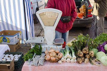 Image showing vegetable lying on market stall near retro scales 