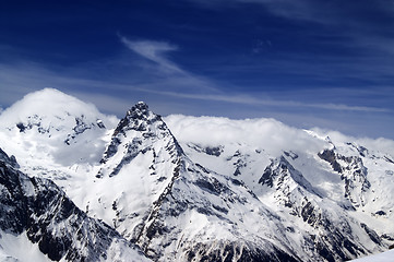 Image showing Snowy mountains and blue sky with clouds