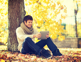 Image showing man with tablet pc in autumn park