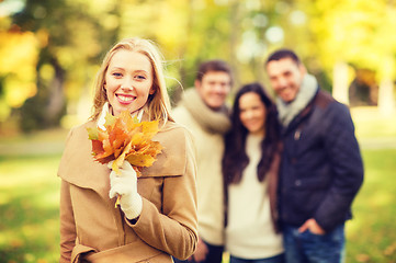 Image showing group of friends having fun in autumn park