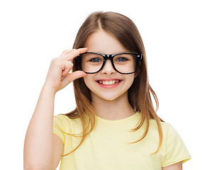 Image showing smiling cute little girl in black eyeglasses