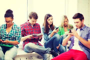 Image showing students looking into devices at school