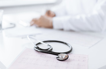 Image showing male doctor hands with cardiogram