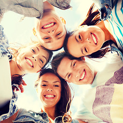 Image showing group of teenagers looking down