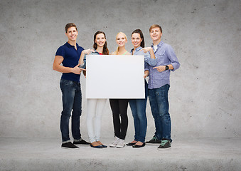 Image showing group of smiling students with white blank board