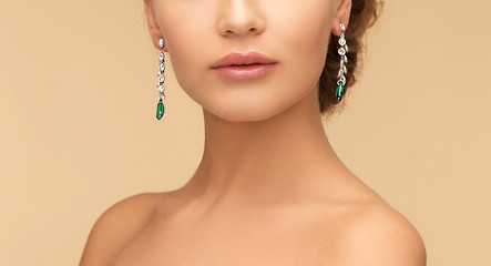 Image showing woman with diamond and emerald earrings