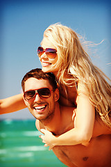 Image showing happy couple in sunglasses on the beach