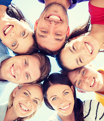 Image showing group of teenagers looking down