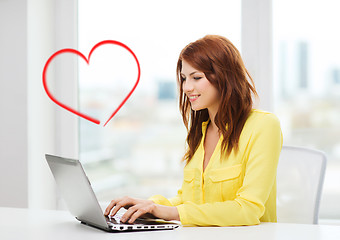 Image showing smiling student with laptop computer at school