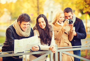 Image showing couples with tourist map and camera in autumn park