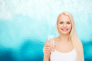 Image showing young smiling woman with glass of water