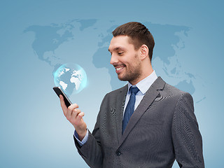 Image showing young smiling businessman with smartphone