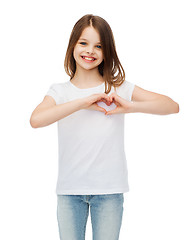 Image showing smiling little girl showing heart with hands