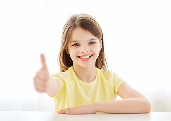 Image showing beautiful little girl at home showing thumbs up