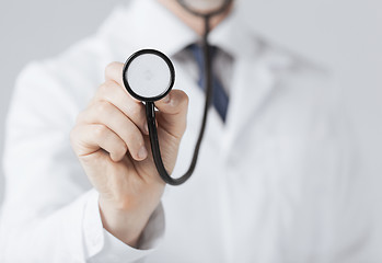 Image showing doctor hand with stethoscope listening something