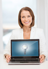 Image showing smiling businesswoman with laptop computer