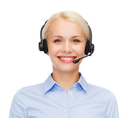 Image showing friendly female helpline operator with headphones