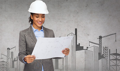 Image showing businesswoman in white helmet with blueprint