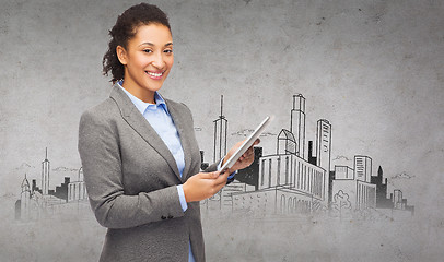 Image showing smiling woman looking at tablet pc