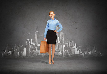 Image showing smiling businesswoman with suitcase