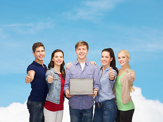 Image showing smiling students with laptop computer