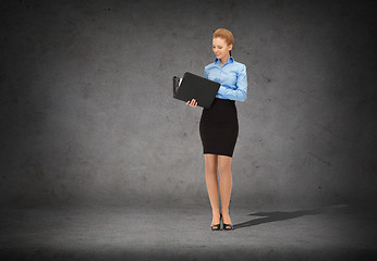 Image showing smiling businesswoman with folder