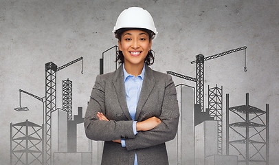 Image showing businesswoman in white helmet with crossed arms