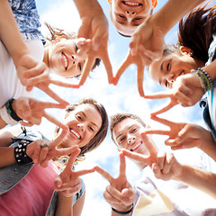 Image showing group of teenagers showing finger five