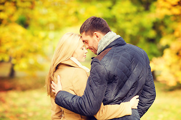 Image showing romantic couple kissing in the autumn park