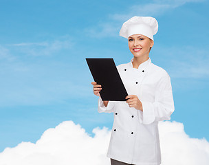 Image showing smiling female chef with black blank paper