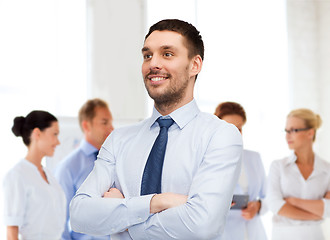 Image showing handsome businessman with crossed arms