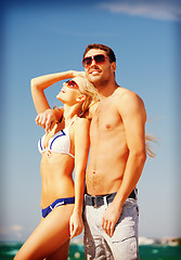 Image showing happy couple in sunglasses on the beach